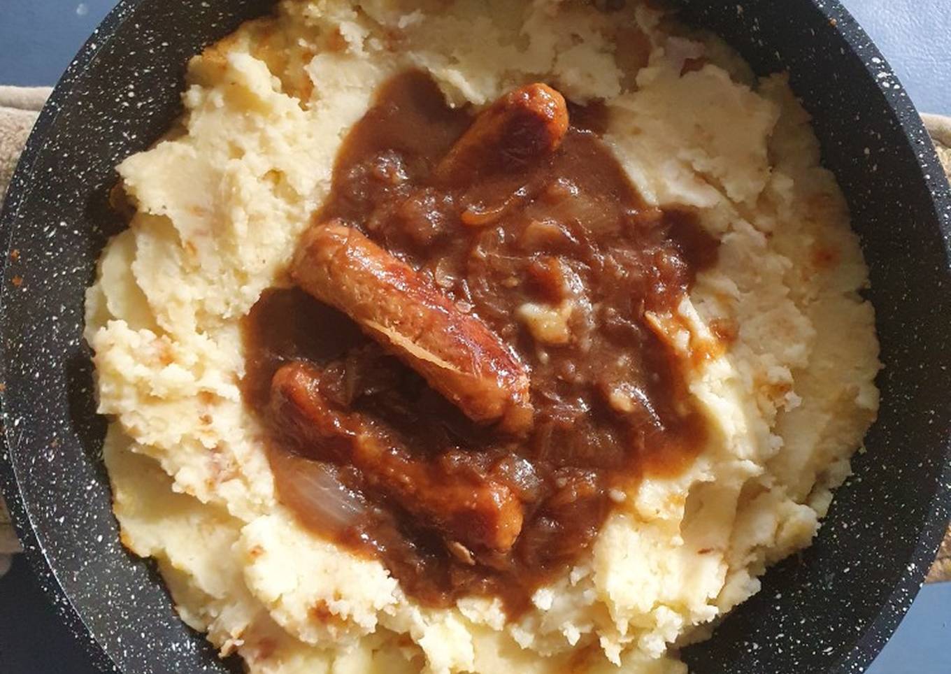 bangers an mash with beef gravy and fried onions
