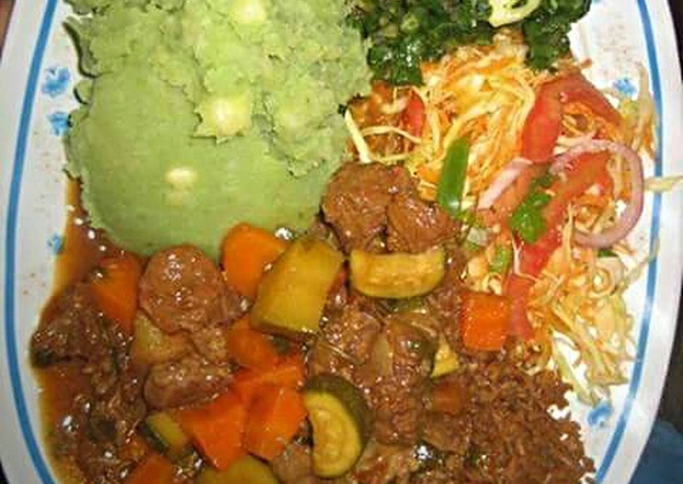 mukimo served with beef stew and green vegetables