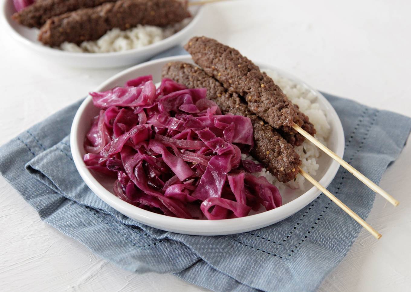 beef kebabs with sauteed red cabbage and rice with fresh thyme