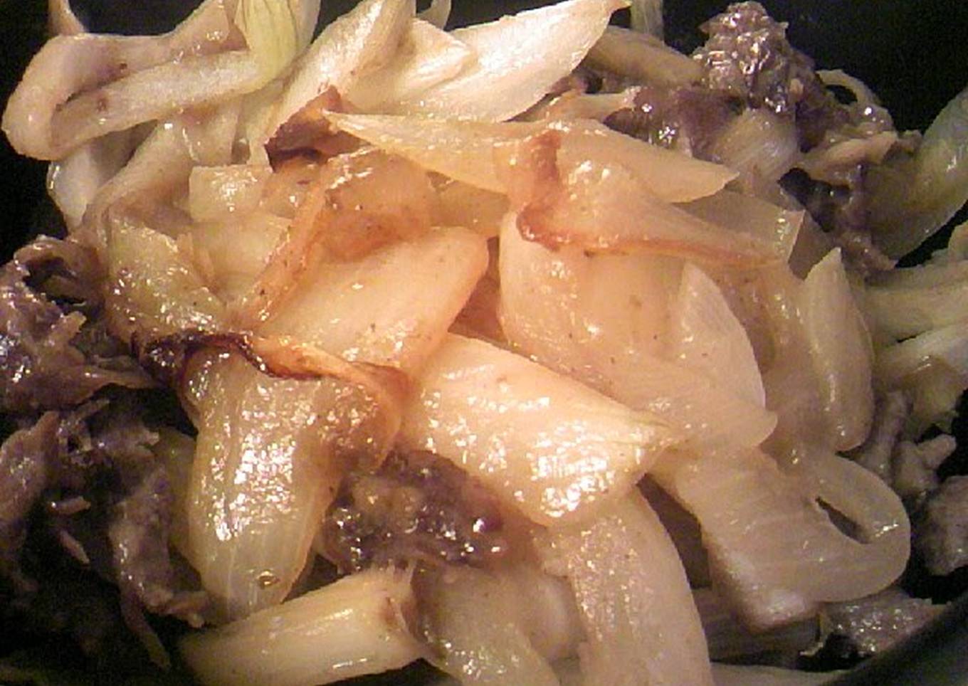 sliced beef and onions in butter soy sauce