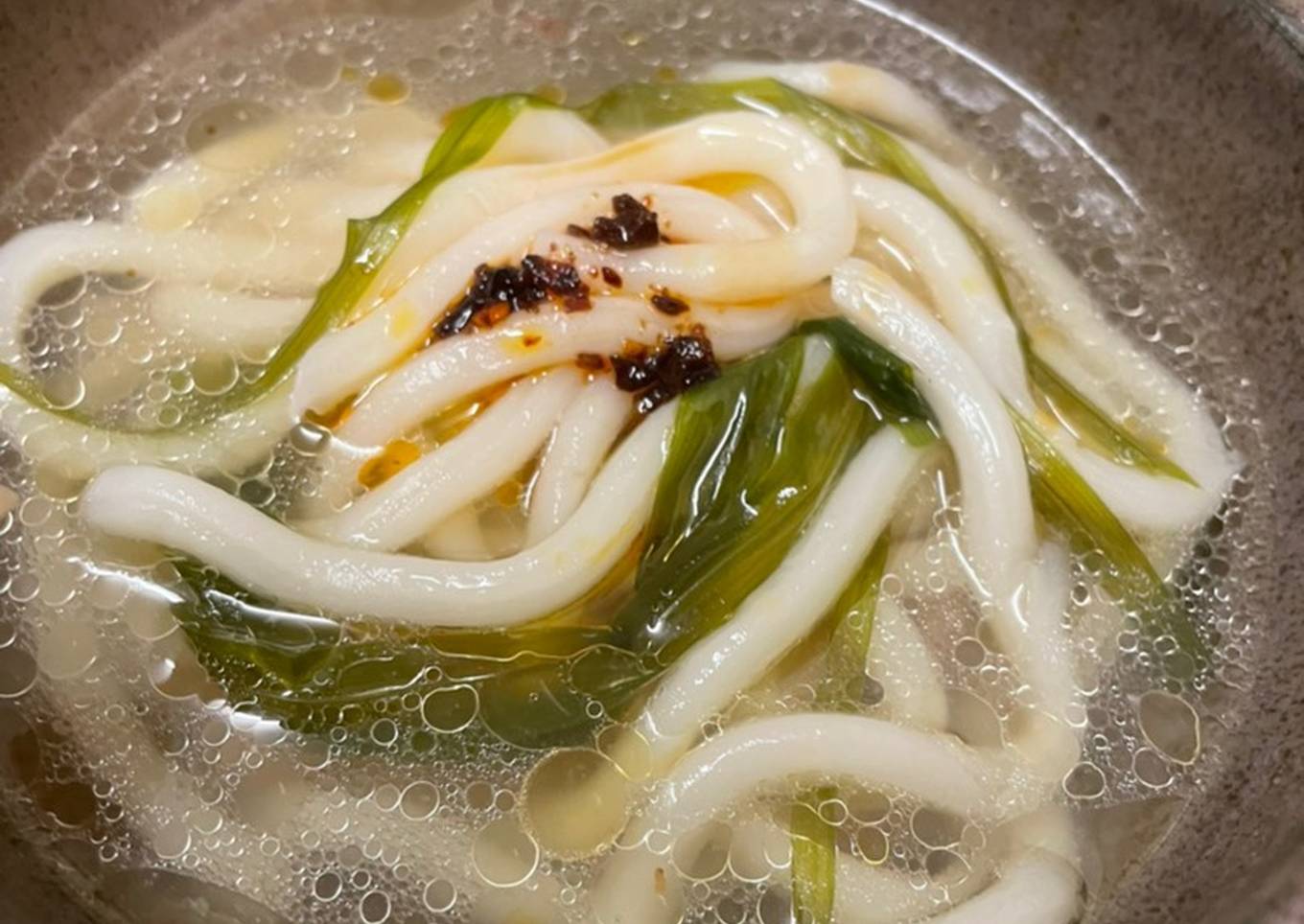 Hainanese chicken and udon noodle broth